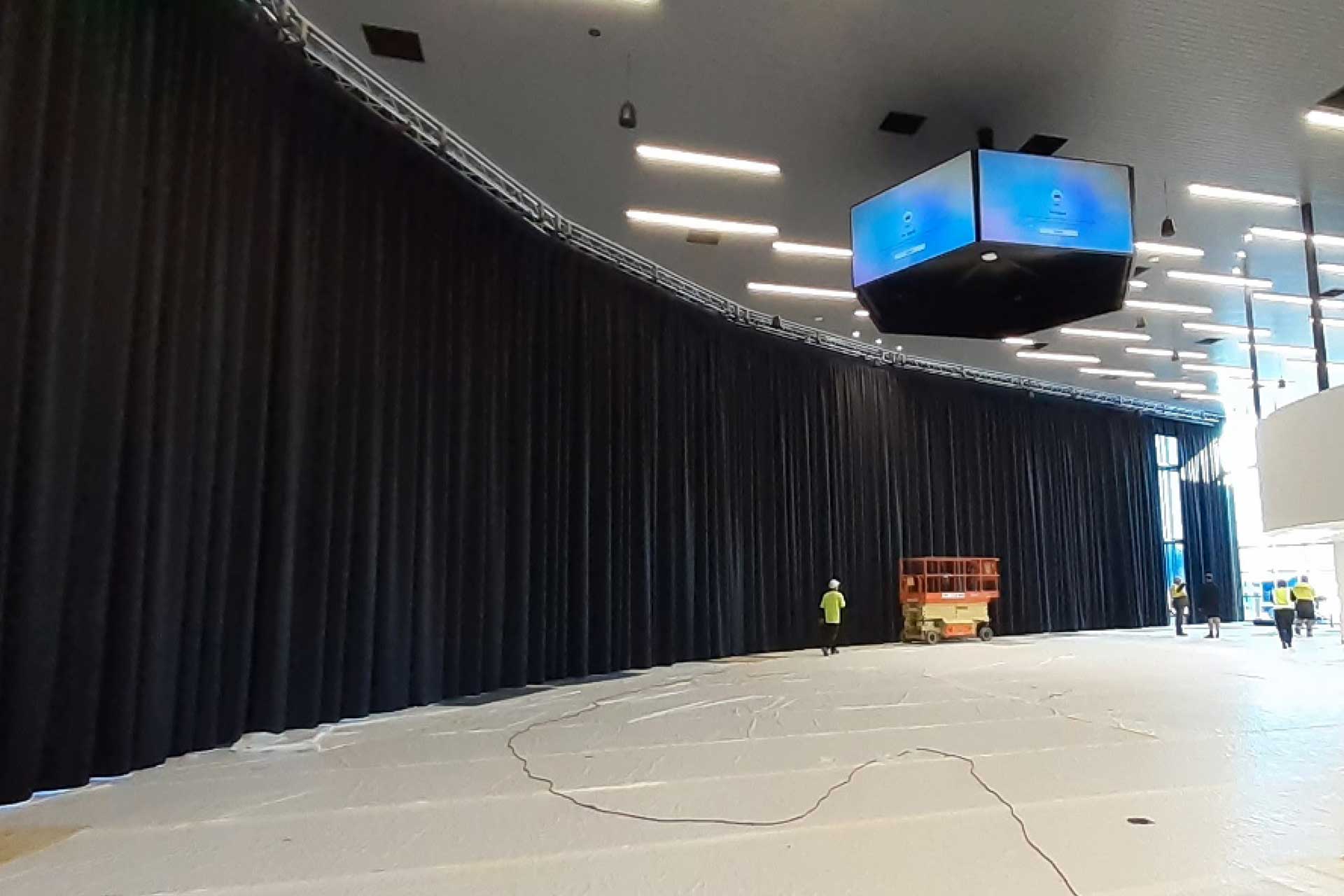 Completed full-height 60m x 8m black curtain system at the Komatsu Distribution Facility